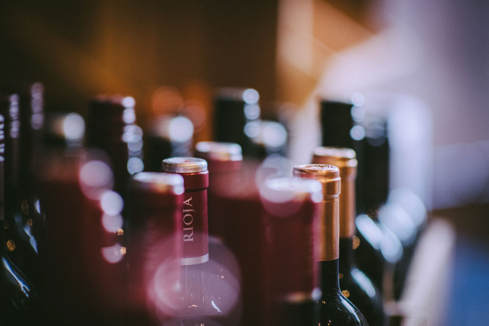Blurred wine bottles tops